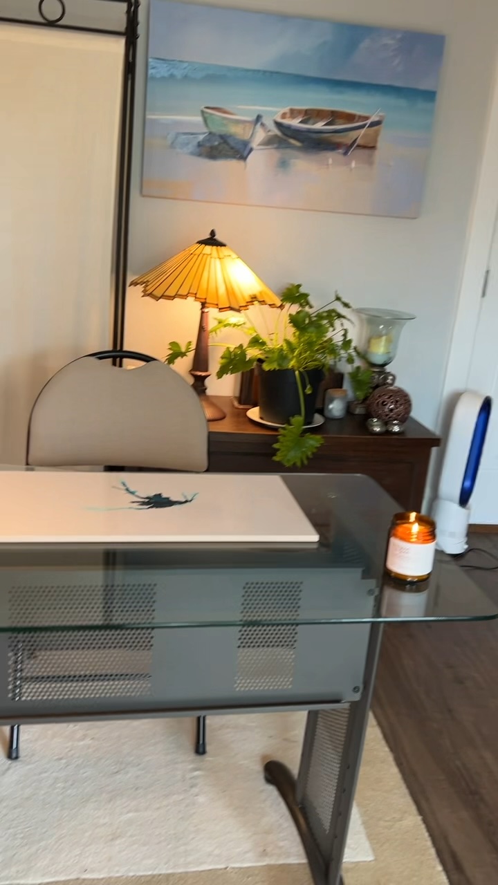 After: The desk facing a seascape painting and lamp-lit console